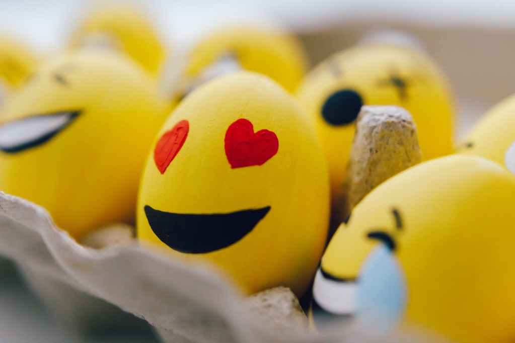 yellow smiley emoji painted eggs
